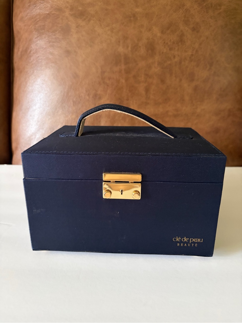 NWOT Cle’ de Peau elegant blue satin small/travel jewelry box. Mirror. Drawer